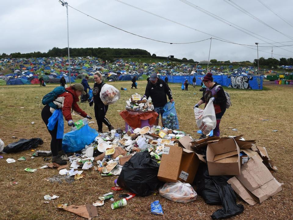 Festival-goers help in the clean up. (AFP via Getty Images)