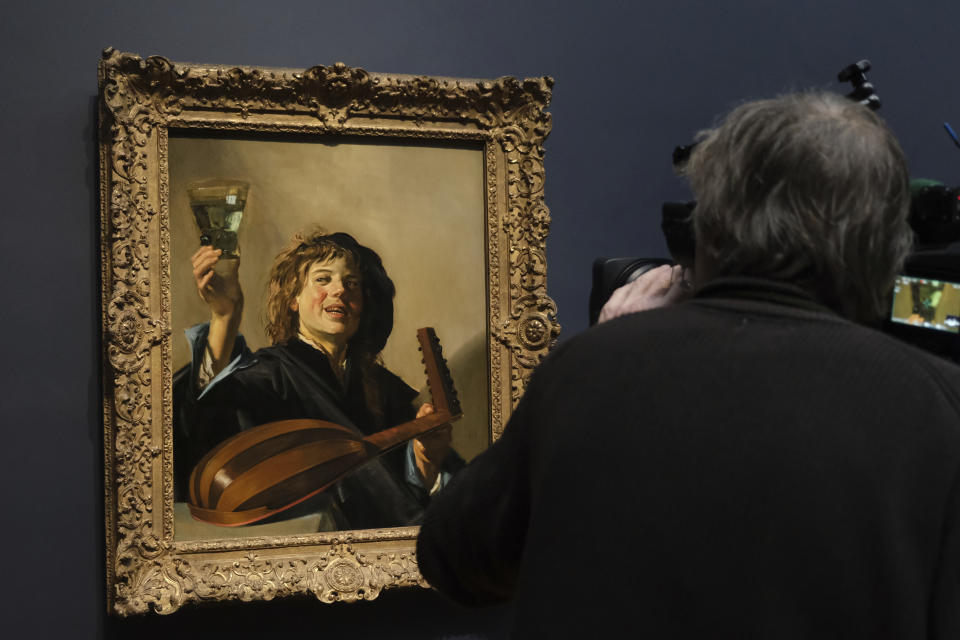 A cameraman films Frans Hals' "The Merry Lute Player" at the Rijksmuseum in Amsterdam, Netherlands, Tuesday, Feb. 13, 2024. Frans Hals is the latest 17th century Dutch master to feature in a major exhibition at the Rijksmuseum in Amsterdam. A show opening on Wednesday highlights Hals' lose brush strokes that made him a forerunner of the impressionist movement. (AP Photo/Michael Corda)