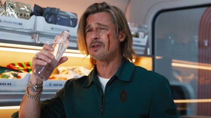 Brad Pitt takes a drink of water in Bullet Train.
