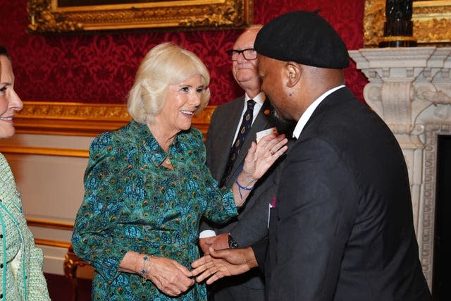 The Queen greeting Sir Ben Okri at the Book Aid International reception