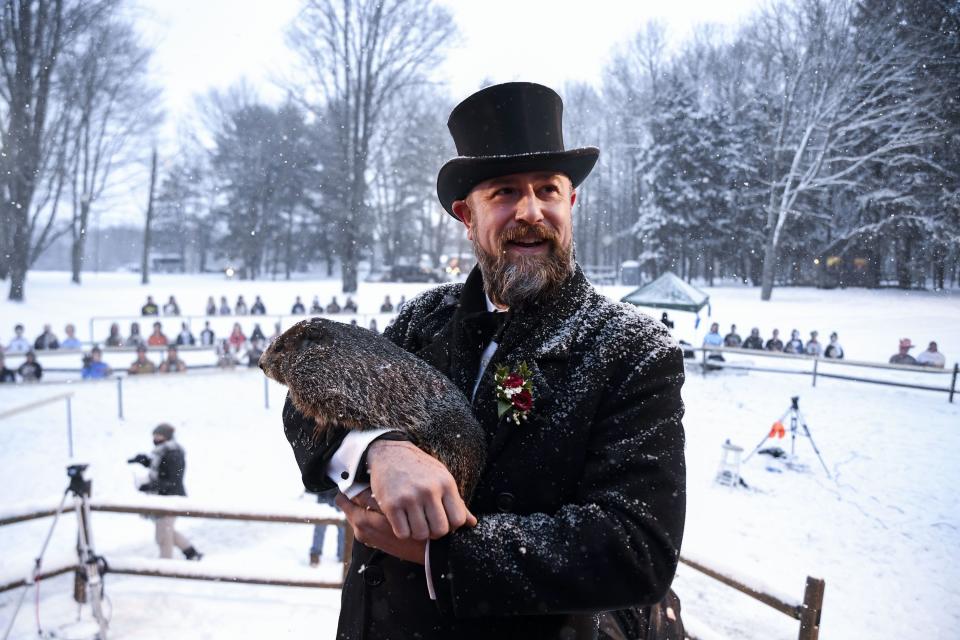 Groundhog Club handler A.J. Dereume holds Punxsutawney Phil, the weather prognosticating groundhog, during the 135th celebration of Groundhog Day on Gobbler’s Knob in Punxsutawney, Pa., Tuesday, Feb. 2, 2021. | Barry Reeger, Associated Press