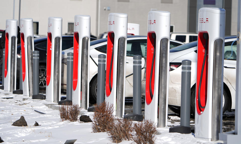 ARCHIVO - Los automovilistas recargan sus vehículos Tesla en un sitio de Supercarga de Tesla, el 16 de enero de 2024, en el noreste de Denver.  El gobernador de Wisconsin, Tony Evers, firmó proyectos de ley bipartidistas el miércoles 20 de marzo de 2024, destinados a iniciar la construcción de una red de carga de vehículos eléctricos a lo largo del sistema interestatal y las principales carreteras de Wisconsin.  (Foto AP/David Zalubowski, archivo)