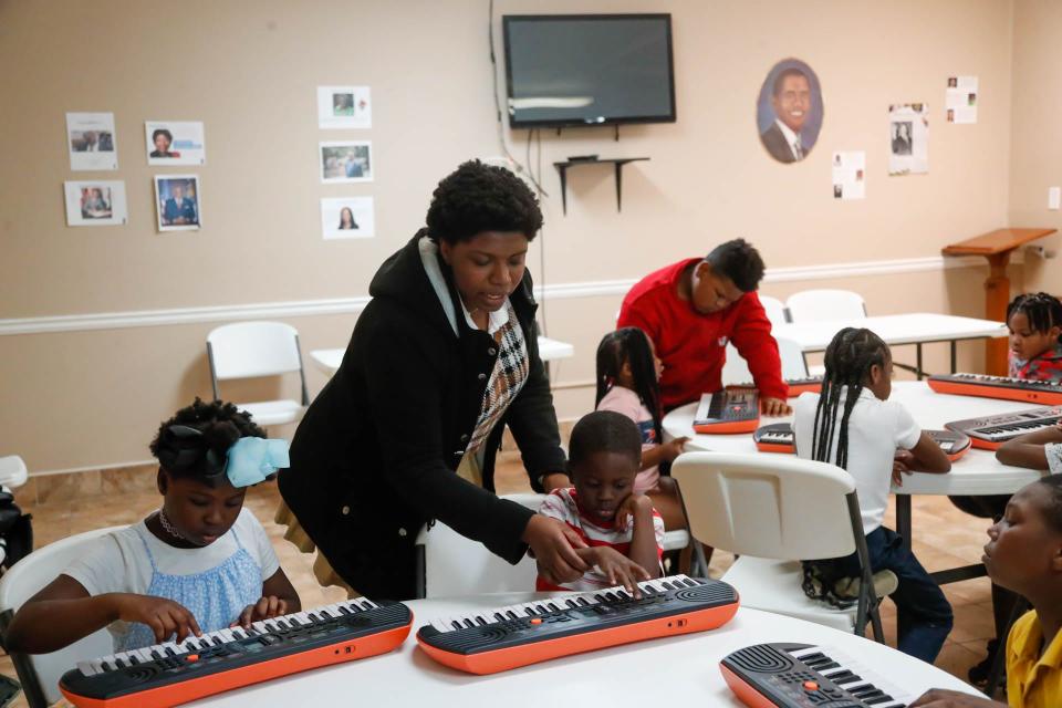 Savannah Arts Academy student Jael Daniel shows young students where to position their fingers during DUETkids piano lessons at Central Missionary Baptist Church.