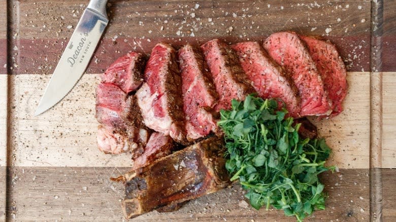 sliced rare steak with bone