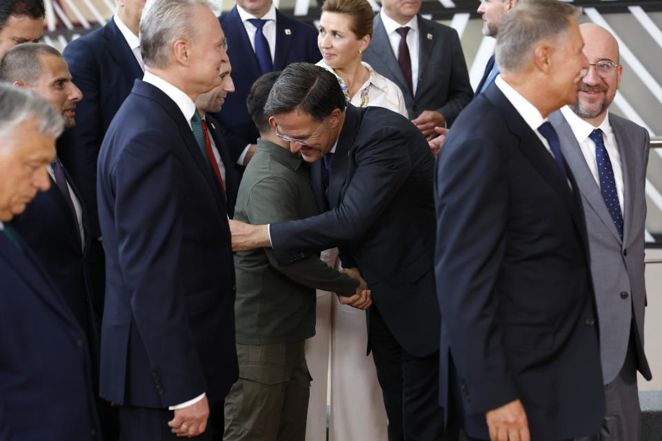 Netherland's Prime Minister Mark Rutte, center right, greets Ukraine's President Volodymyr Zelenskyy, center left, during a group photo at an EU summit in Brussels, Thursday, June 27, 2024. European Union leaders are expected on Thursday to discuss the next EU top jobs, as well as the situation in the Middle East and Ukraine, security and defence and EU competitiveness. (AP Photo/Geert Vanden Wijngaert)