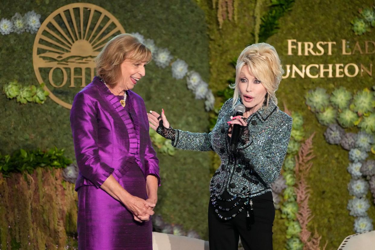 Dolly Parton speaks to Fran DeWine during the Ohio First Lady's luncheon to celebrate the success and raise money for Dolly Parton's Imagination Library of Ohio, Tuesday, Aug 9, 2022; Columbus, Ohio. (Adam Cairns/The Columbus Dispatch via AP) ORG XMIT: OHCOL500