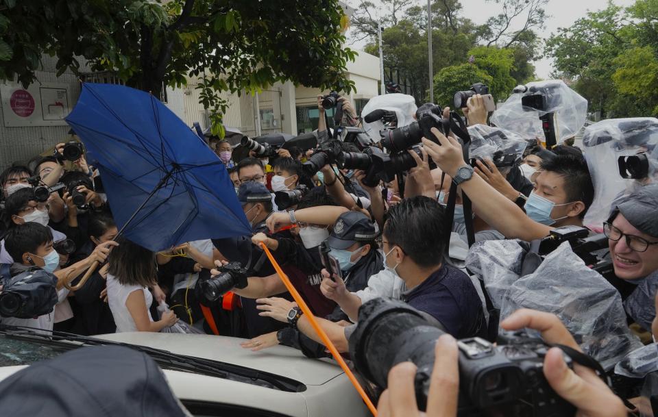 Photographers surround a van which is carrying Agnes Chow, a prominent pro-democracy activist who was sentenced to jail last year for her role in an unauthorized protest, after she was released in Hong Kong Saturday, June 12, 2021. Chow rose to prominence as a student leader in the now defunct Scholarism and Demosisto political groups, alongside other outspoken activists such as Joshua Wong and Ivan Lam. (AP Photo/Vincent Yu)