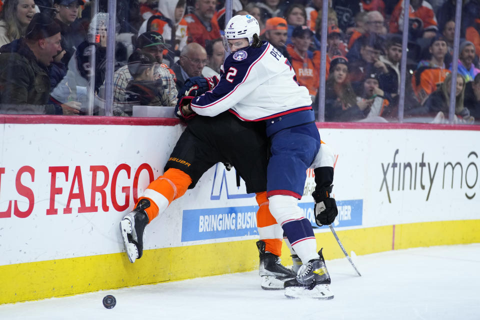 Columbus Blue Jackets' Andrew Peeke, right, collides with Philadelphia Flyers' Travis Sanheim during the second period of an NHL hockey game, Tuesday, Dec. 20, 2022, in Philadelphia. (AP Photo/Matt Slocum)