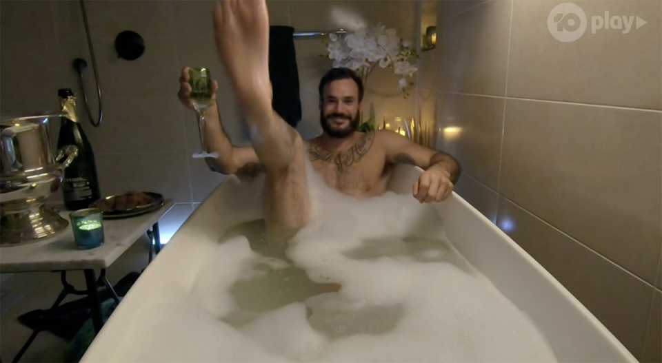 Locky lifts leg up in bath