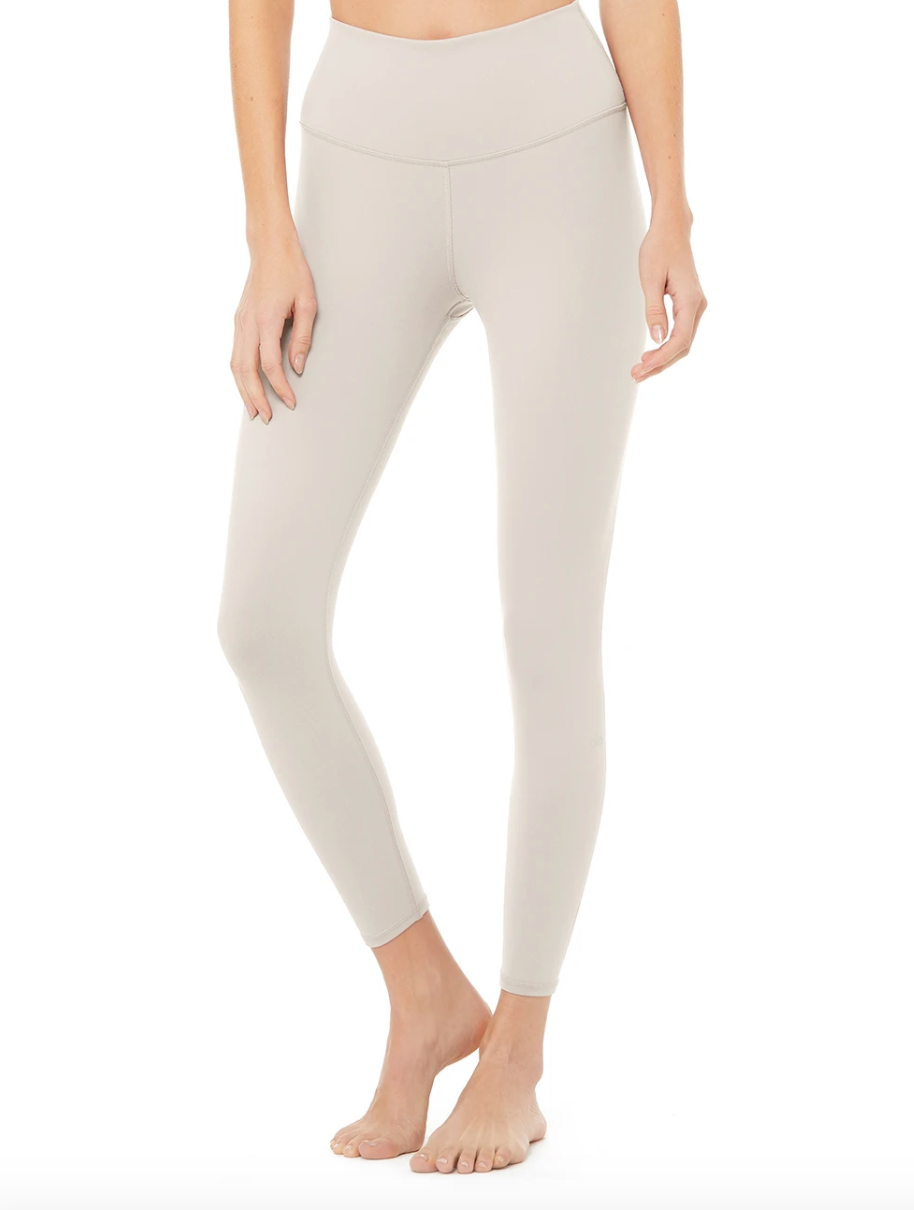 The 7/8 High Waist Yoga Legging in Bone by Alo Yoga. 