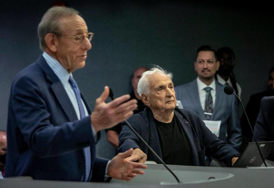 Miami Dolphins owner Stephen Ross, left, speaks to the Miami Beach City Commission on July 20, 2022, as architect Frank Gehry listens before the start of a presentation regarding development of the historic Deauville site.