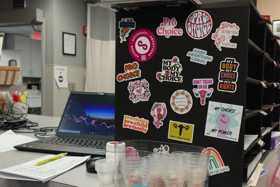 A paperwork section covered with reproductive healthcare stickers.