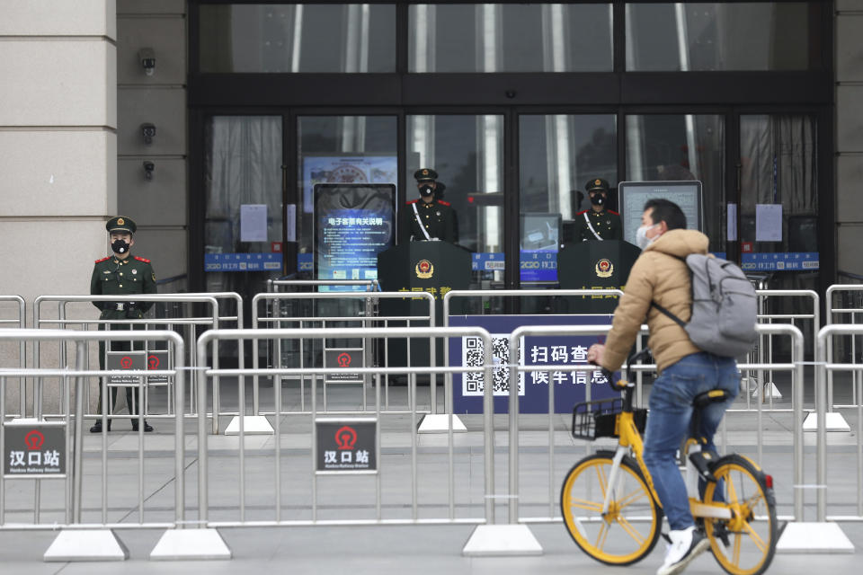 A man rides his bicycle past the closed Hankou Railway Station in Wuhan in central China's Hubei Province, Thursday, Jan. 23, 2020. Overnight, Wuhan authorities announced that the airport and train stations would be closed, and all public transportation suspended by 10 a.m. Friday. Unless they had a special reason, the government said, residents should not leave Wuhan, the sprawling central Chinese city of 11 million that's the epicenter of an epidemic that has infected nearly 600 people. (Chinatopix via AP)