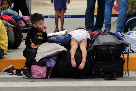 Venezuelan migrant children wait at the Binational Border Service Center of Peru, in Tumbes