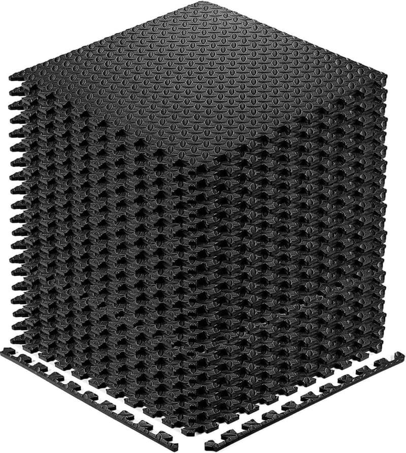 A stack of black foam mats that fit together like a puzzle