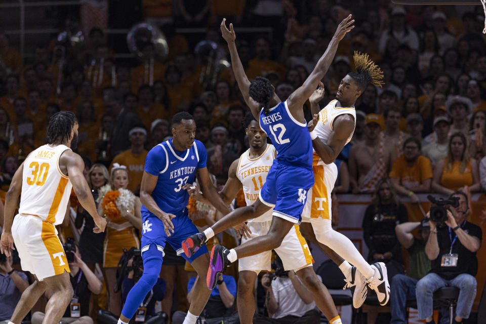 Kentucky guard Antonio Reeves (12) collides with Tennessee guard Jahmai Mashack (15) as he goes up for a shot during the first half of an NCAA college basketball game Saturday, March 9, 2024, in Knoxville, Tenn. (AP Photo/Wade Payne)