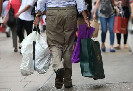 Shoppers carry bags in London, Britain August 25, 2016. REUTERS/Neil Hall