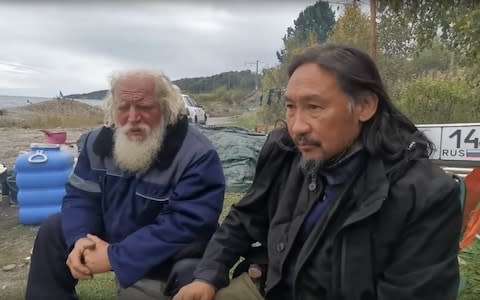 Viktor Yegorov and Mr Gabyshev rest at a camp near Lake Baikal this week - Credit: YouTube