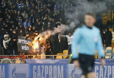 Football Soccer - FC Dynamo Kyiv v Besiktas - UEFA Champions League Group Stage - Group B - NSC Olimpiyskiy Stadium, Kiev, Ukraine - 6/12/16. Dynamo Kyiv's fans burn a Besiktas' banner during the match. REUTERS/Gleb Garanich