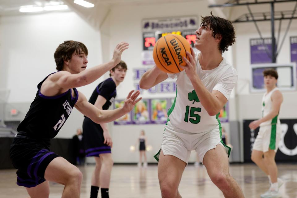Bishop McGuinness' Cooper Bradley (15) goes against Bethany's Wyatt Geissler during a high school basketball game Thursday, Feb. 22, 2024, at Bethany High School.