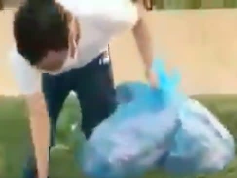 Fadel Alkilani, a student at Washington University, removes American flags from a campus Republican-built 9/11 memorial. He said the removal was an act of protest.  (screengrab)