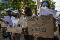 Anti-coup protesters hold signs that refer to R2P, which means Responsibility to Protect, during a gathering in Ahlone township in Yangon, Myanmar Monday, April 12, 2021. The protesters have called for foreign intervention to aid them under the doctrine of Responsibility to Protect, or R2P, devised to deal with matters such as genocide, war crimes, ethnic cleansing and crimes against humanity. (AP Photo)