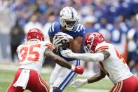 Indianapolis Colts wide receiver Michael Pittman Jr. makes a catch against Kansas City Chiefs' Jaylen Watson (35) and Darius Harris (47) during the first half of an NFL football game, Sunday, Sept. 25, 2022, in Indianapolis. (AP Photo/Michael Conroy)