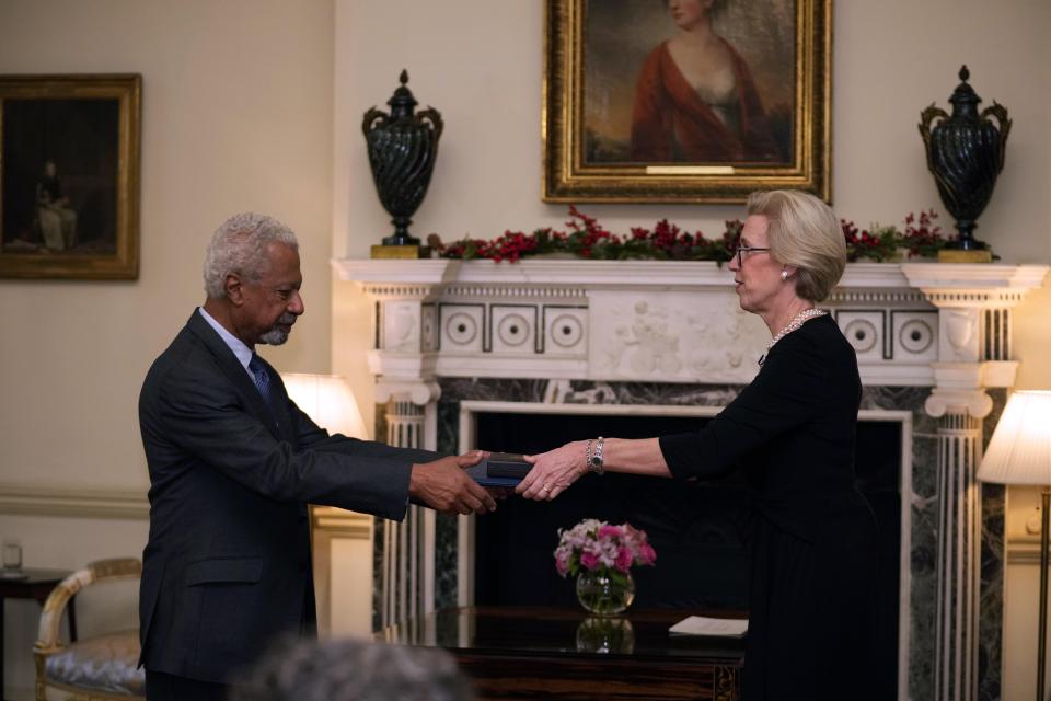 Abdulrazak Gurnah, a Tanzanian-born novelist and emeritus professor who lives in the UK, is presented with the 2021 Nobel Prize for Literature medal and diploma by the Ambassador of Sweden Mikaela Kumlin Granit, during a ceremony at the Swedish Ambassador's Residence in London, Monday, Dec. 6, 2021. The 2021 Nobel Prize ceremonies are being reined in and scaled-down for the second year in a row due to the coronavirus pandemic, with the laureates receiving their Nobel Prize medals and diplomas in their home countries. (AP Photo/Matt Dunham)