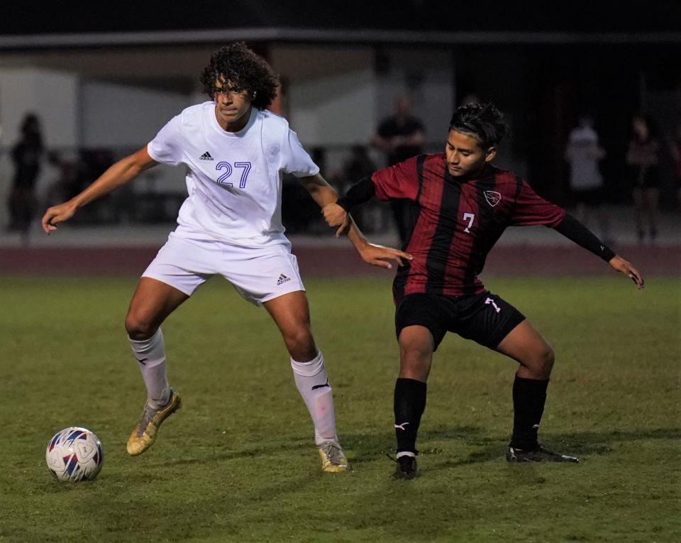 South Fork senior Matias Mendoza defends a John Carroll Catholic player during a high school soccer match on Tuesday, Nov. 7, 2023.