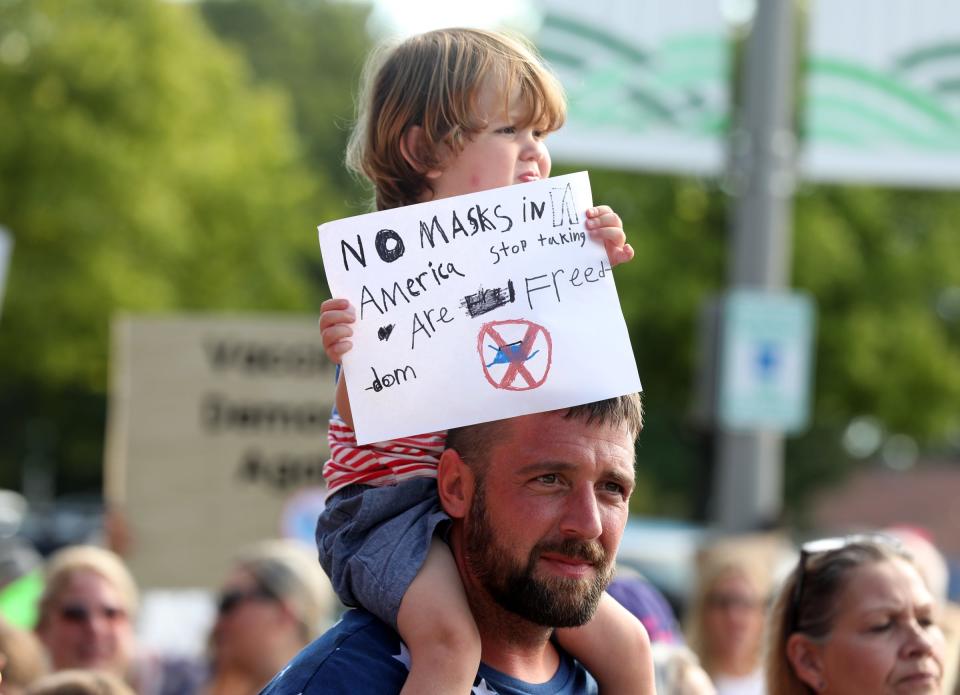 Colin Clements, 35 of Davisburg, Michigan, and his son Cameron Clements, 2, were among at least 200 protesters rallying against the wearing of masks for kids in Oakland County schools in front of the Oakland County Health Department in Pontiac on Wednesday, Aug. 25, 2021.