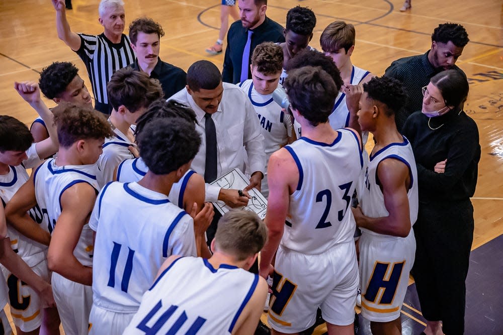 Hickman head coach Cray Logan talks with his team during a game against Capital City on Dec. 13 at Hickman High School.