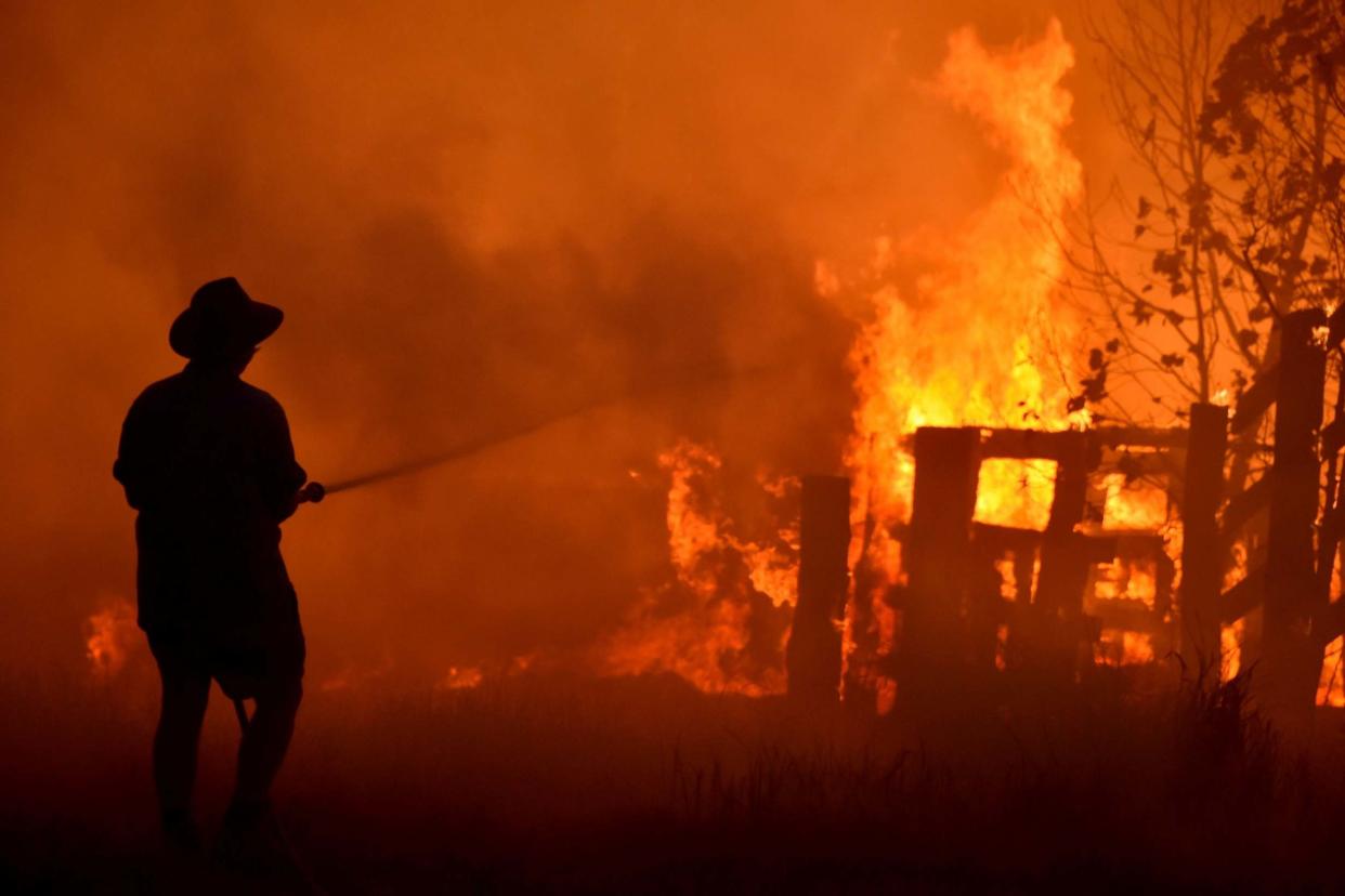 Residents attempt to defend a property from a bushfire near Taree, 350km north of Sydney: AFP/Getty