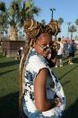 A festivalgoer rocks two-strand twisted topknots with blond highlights.