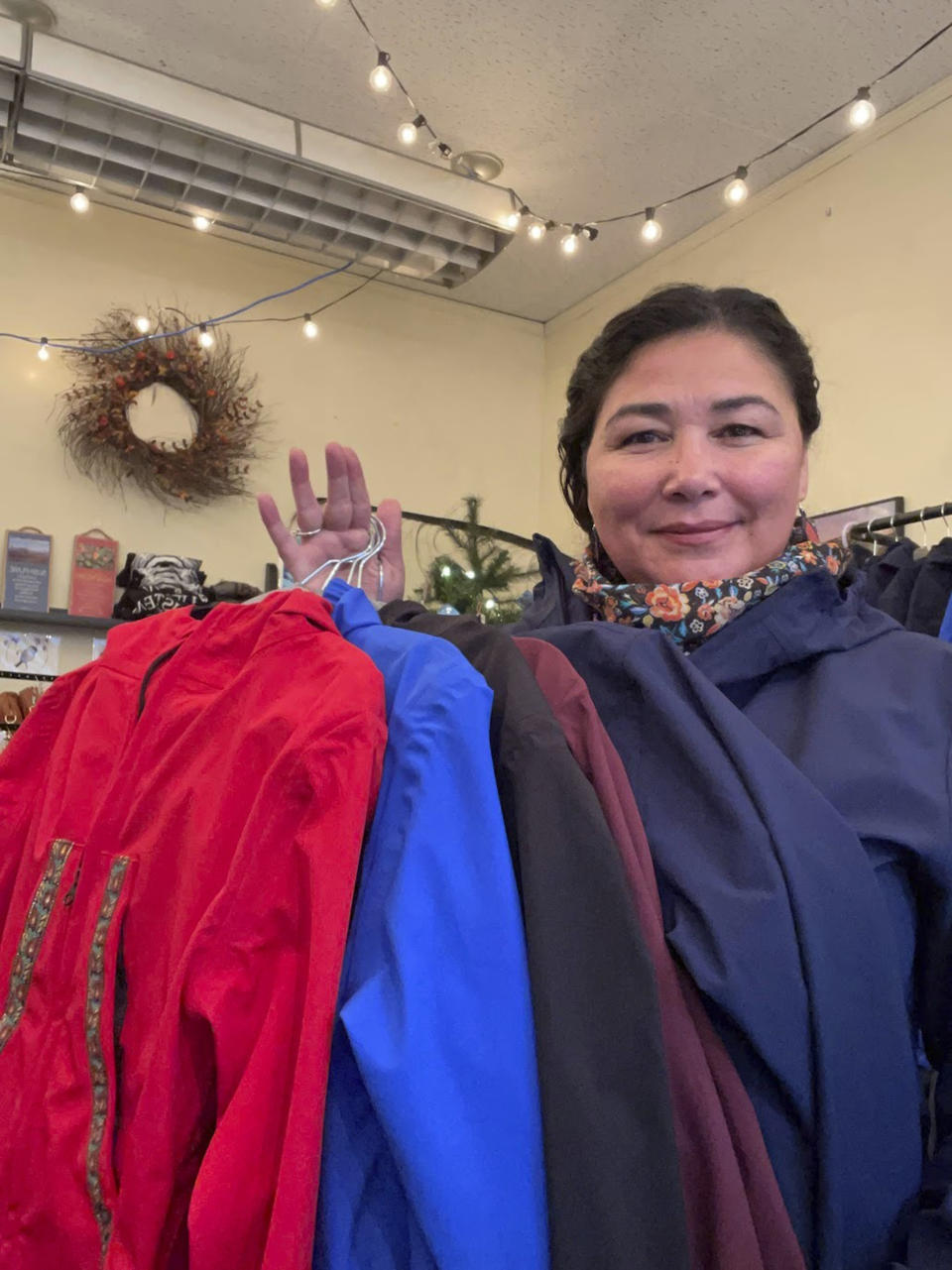 This undated photo shows Alice Bioff displaying Atmik, water-proof garments she makes that resembles the traditional Alaska Native garment called a kuspuk in Nome, Alaska. The garment was inspired by a tourist she met in 2016 when she was a tour guide, and she hopes the $600 million expansion of the Port of Nome will translate into support of Nome stores and Indigenous artists. (Alice Bioff via AP)