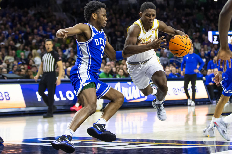 Notre Dame's Markus Burton, right, drives against Duke's Jeremy Roach during the second half of an NCAA college basketball game Saturday, Jan. 6, 2024, in South Bend, Ind. (AP Photo/Michael Caterina)