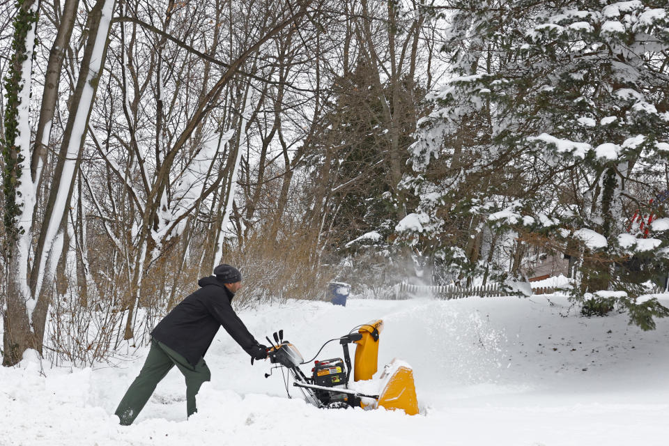 A person clears snow with a snow blower after a winter storm rolled through Western New York Tuesday, Dec. 27, 2022, in Amherst, N.Y. (AP Photo/Jeffrey T. Barnes)
