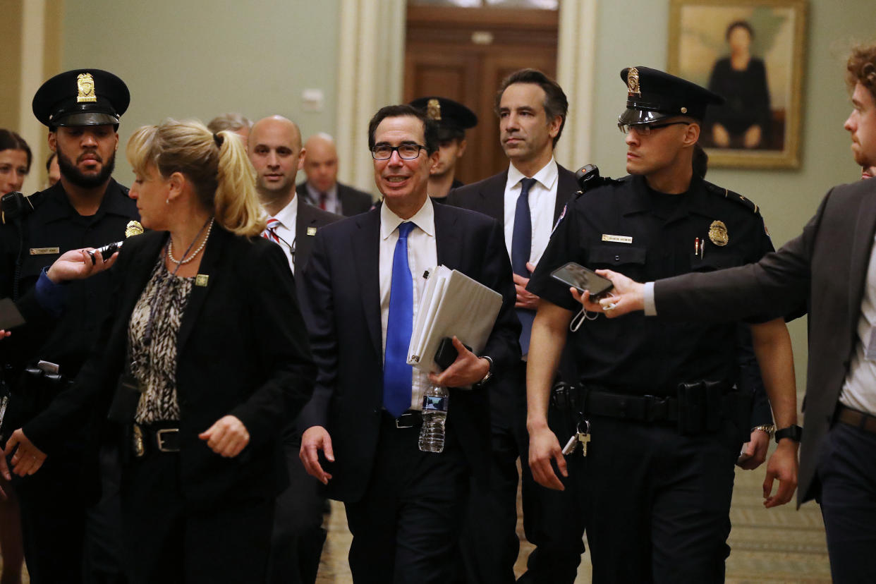 WASHINGTON, DC - MARCH 24:  Treasury Secretary Steven Mnuchin (C) leaves the offices of Minority Leader Charles Schumer (D-NY) as negotiations continue into the night on a $2 trillion economic stimulus in response to the coronavirus pandemic at the U.S. Capitol March 24, 2020 in Washington, DC. After days of tense negotiations -- and Democrats twice blocking the nearly $2 trillion package -- the Senate and Treasury Department appear to have reached important compromises on legislation to shore up the economy during the COVID-19 pandemic. (Photo by Chip Somodevilla/Getty Images)