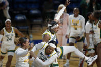 At the end of the first half Baylor forward NaLyssa Smith, top, celebrates with teammates in a college basketball game against Virginia Tech in the second round of the women's NCAA tournament at the Greehey Arena in San Antonio, Tuesday, March 23, 2021. (AP Photo/Ronald Cortes)