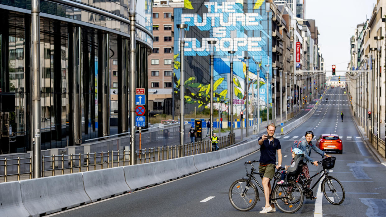 People on bicycles pose for a photo on a car-free Sunday