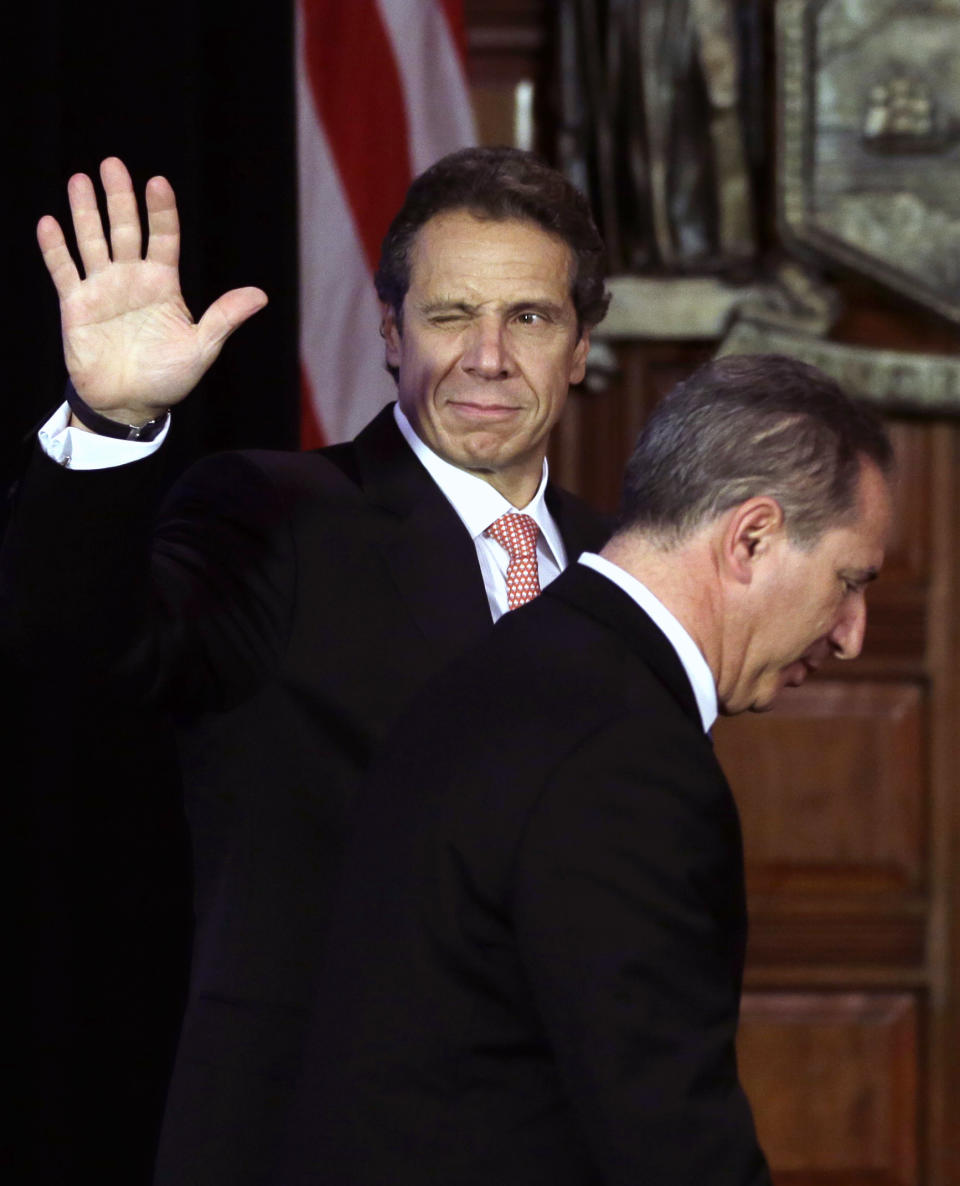 New York Gov. Andrew Cuomo, left, winks and waves as he and Howard Glaser, New York state director of operations, leave the Red Room after a cabinet meeting at the Capitol on Thursday, Sept. 27, 2012, in Albany, N.Y. Cuomo is calling a summit to boost the beer and wine industries in New York just months after a similar effort began to try to make New York the nations largest producer of Greek-style yogurt. (AP Photo/Mike Groll)