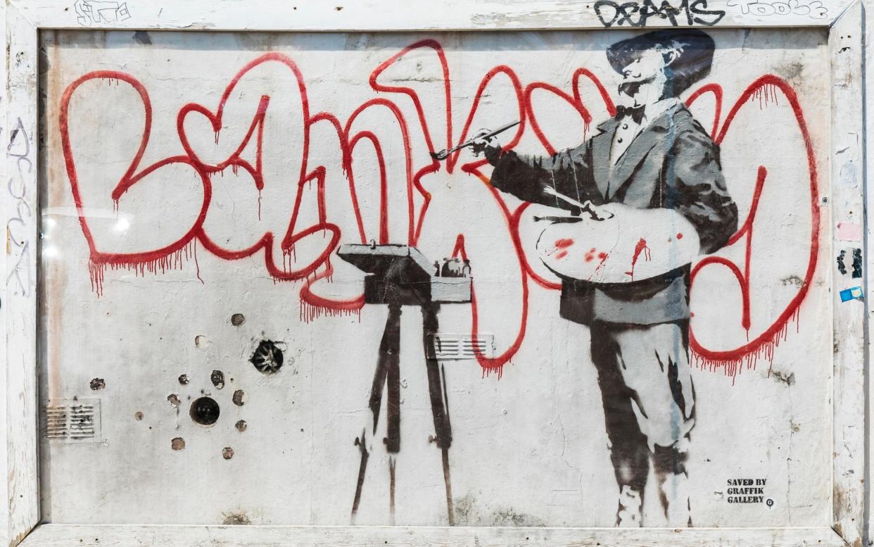 This Banksy piece, from the side of a house in West London, is being relocated to a higher part of the same wall in a development called Sartoria House - Copyright Â© Grant Frazer