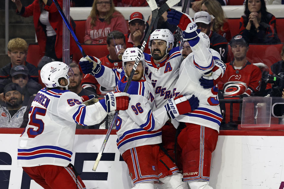 New York Rangers' Chris Kreider, second from right, celebrates his goal against the Carolina Hurricanes with teammates during the third period in Game 6 of an NHL hockey Stanley Cup second-round playoff series in Raleigh, N.C., Thursday, May 16, 2024. (AP Photo/Karl B DeBlaker)