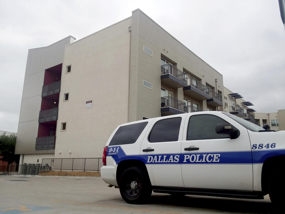 FILE - In this Sept. 10, 2018, file photo, a Dallas Police vehicle is parked near the South Side Flats apartments in Dallas. Former Dallas Police Officer Amber Guyger fatally shot an unarmed black neighbor whose apartment she said she entered by mistake, believing it to be her own. It’s unclear when Guyger first talked to investigators about the September 2018 shooting, but she was eventually charged and is serving 10 years in prison after being convicted of murder this month. (AP Photo/Ryan Tarinelli, File)