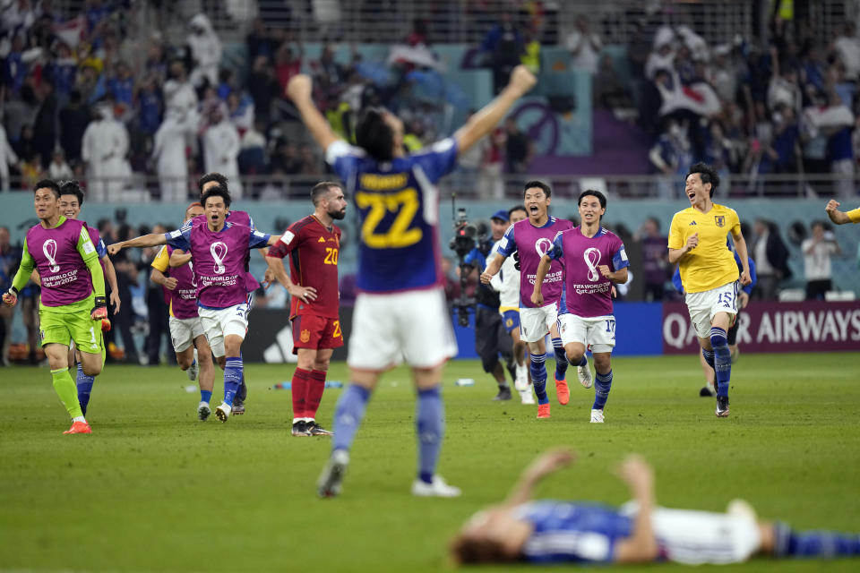 Japan players celebrate after defeating Spain 2-1 after the World Cup group E soccer match between Japan and Spain, at the Khalifa International Stadium in Doha, Qatar, Thursday, Dec. 1, 2022. (AP Photo/Aijaz Rahi)