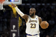Los Angeles Lakers forward LeBron James (23) directs his teammates as he dribbles up the court during the first half of an NBA basketball game against the Cleveland Cavaliers, Saturday, April 6, 2024, in Los Angeles. (AP Photo/William Liang)