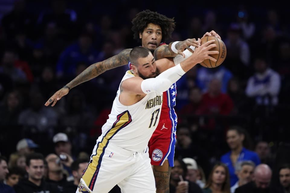 Philadelphia 76ers' Kelly Oubre Jr., top, fouls New Orleans Pelicans' Jonas Valanciunas during the first half of an NBA basketball game, Friday, March 8, 2024, in Philadelphia. (AP Photo/Matt Slocum)
