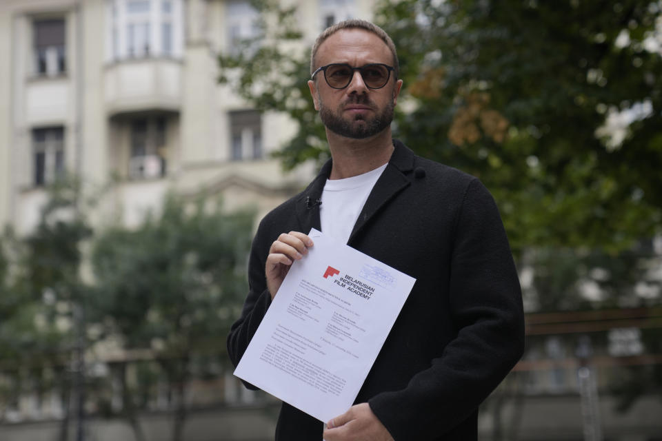 The prominent critic of the Belarusian government in Minsk, Andrei Hniot, shows an appeal in front of the presidency building in Belgrade, Serbia, Monday, Sept. 16, 2024. (AP Photo/Darko Vojinovic)