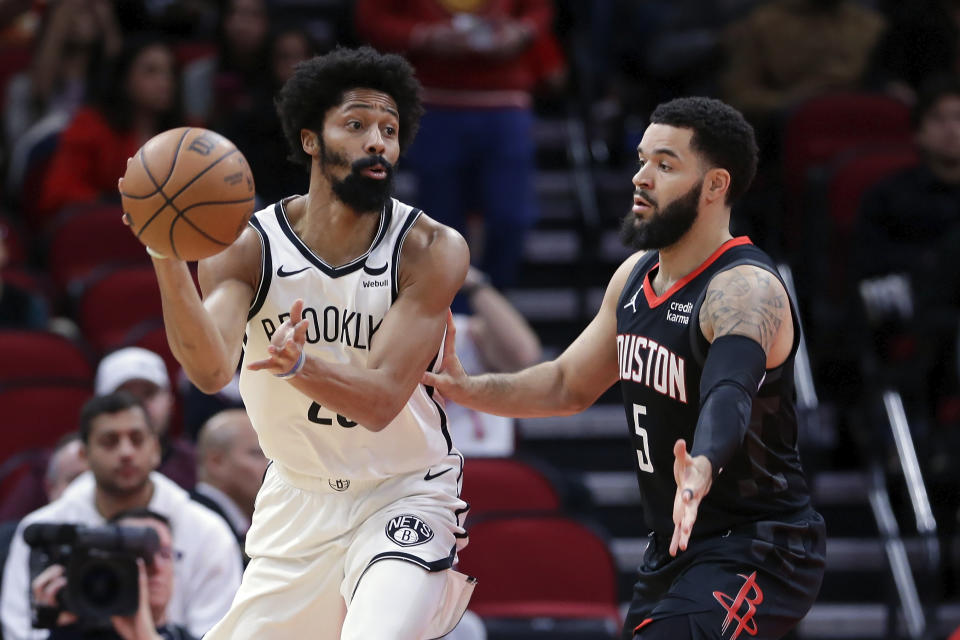 Brooklyn Nets guard Spencer Dinwiddie, left, passes the ball under pressure from Houston Rockets guard Fred VanVleet (5) during the first half of an NBA basketball game Wednesday, Jan. 3, 2024, in Houston. (AP Photo/Michael Wyke)