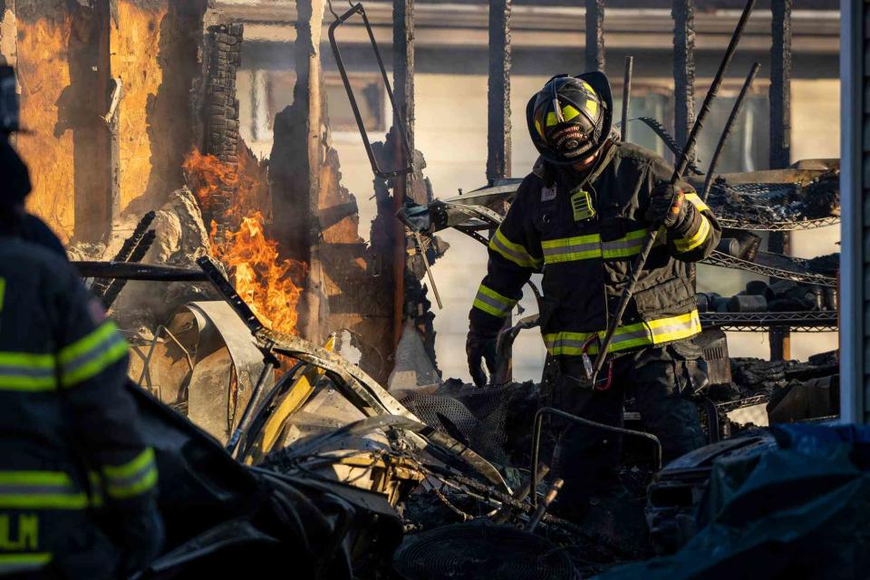 <p>Leila Navidi/Star Tribune via AP</p> Fire crews work to put out a fire after a home exploded, Thursday, Nov. 30, 2023, in South St. Paul, Minn.