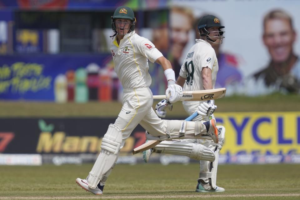 Australia's Marnus Labuschagne, left, runs between wickets with his batting partner Steven Smith during the first day of the second cricket test match between Australia and Sri Lanka in Galle, Sri Lanka, Friday, July 8, 2022. (AP Photo/Eranga Jayawardena)